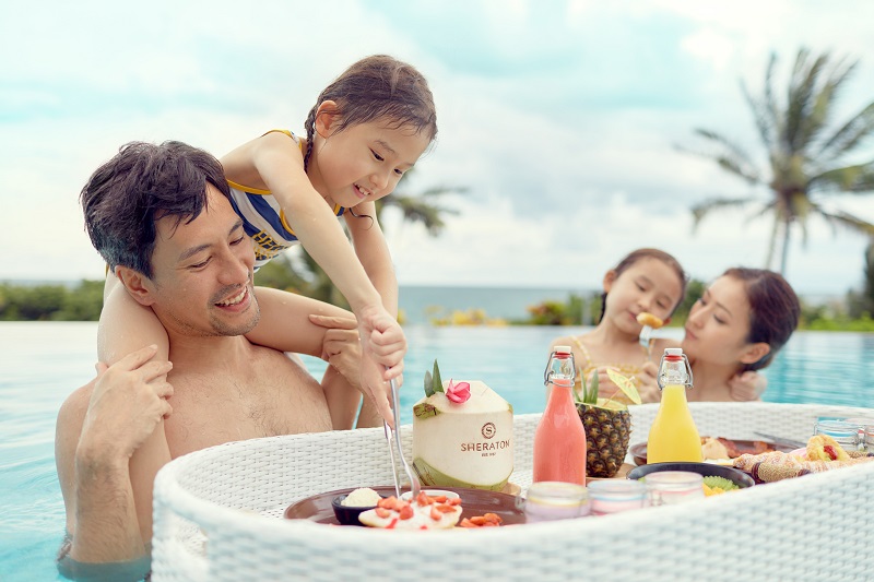 family in the pool with floating breakfast